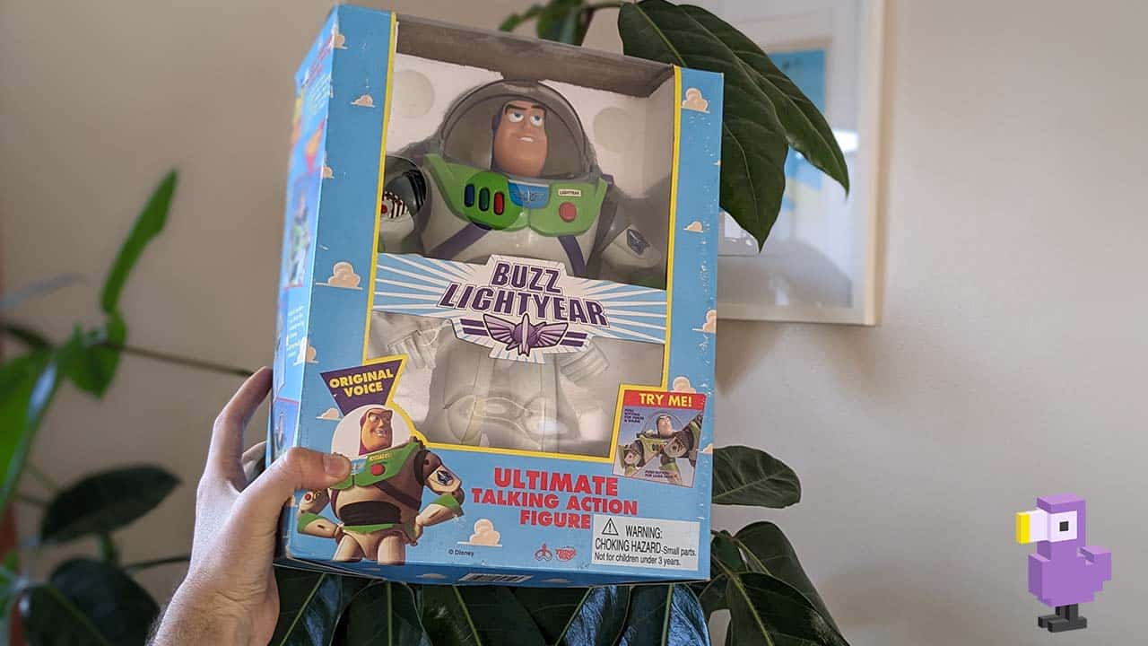 Buzz Lightyear held by Theo. The toy is in its original box based on the Toy Story movie