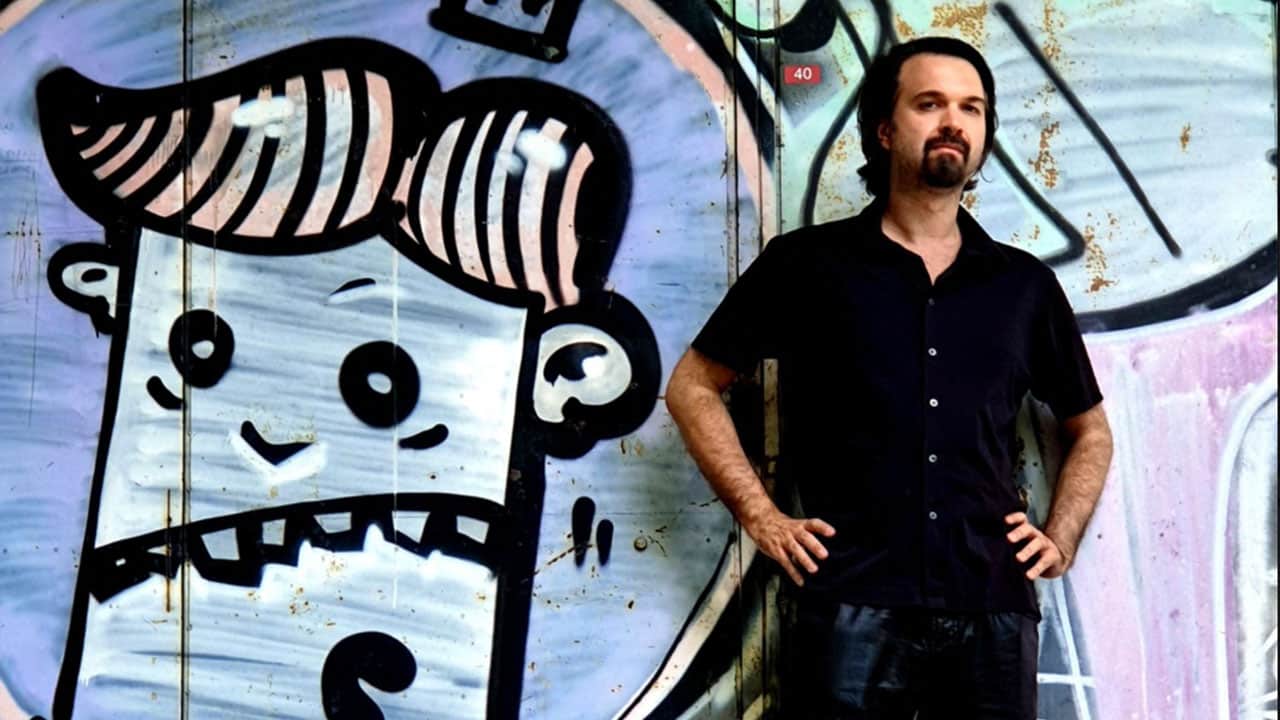 Remute standing next to graffiti