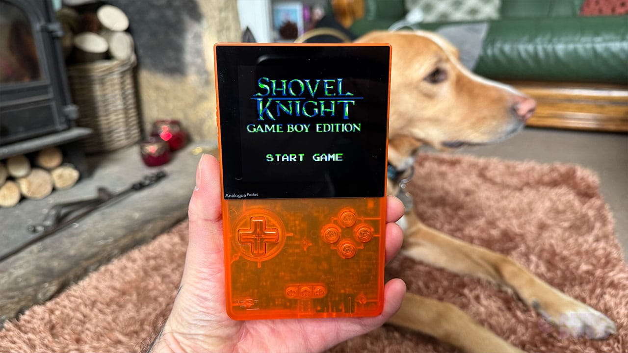 Seb holding his Analogue Pocket next to his dog.