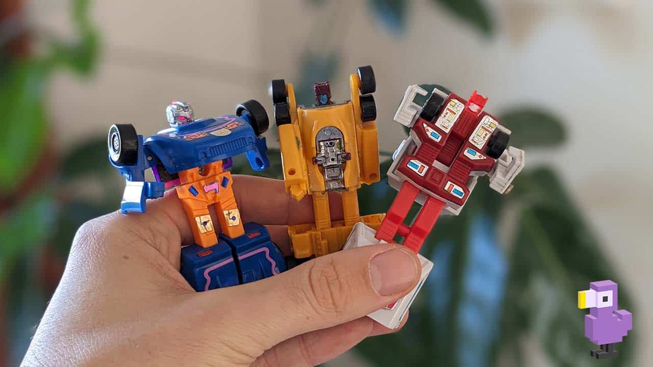 Theo holding 3 transformers toys in his hand
